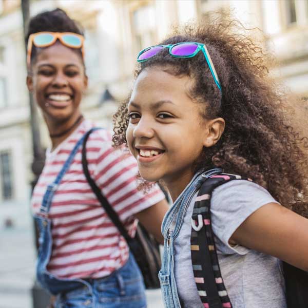 mother and daughter walk to school